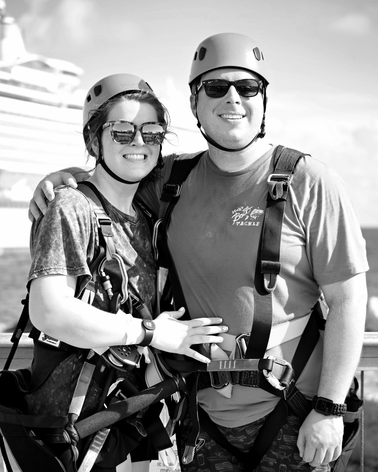 Isaiah and his partner smiling together in zip-line gear