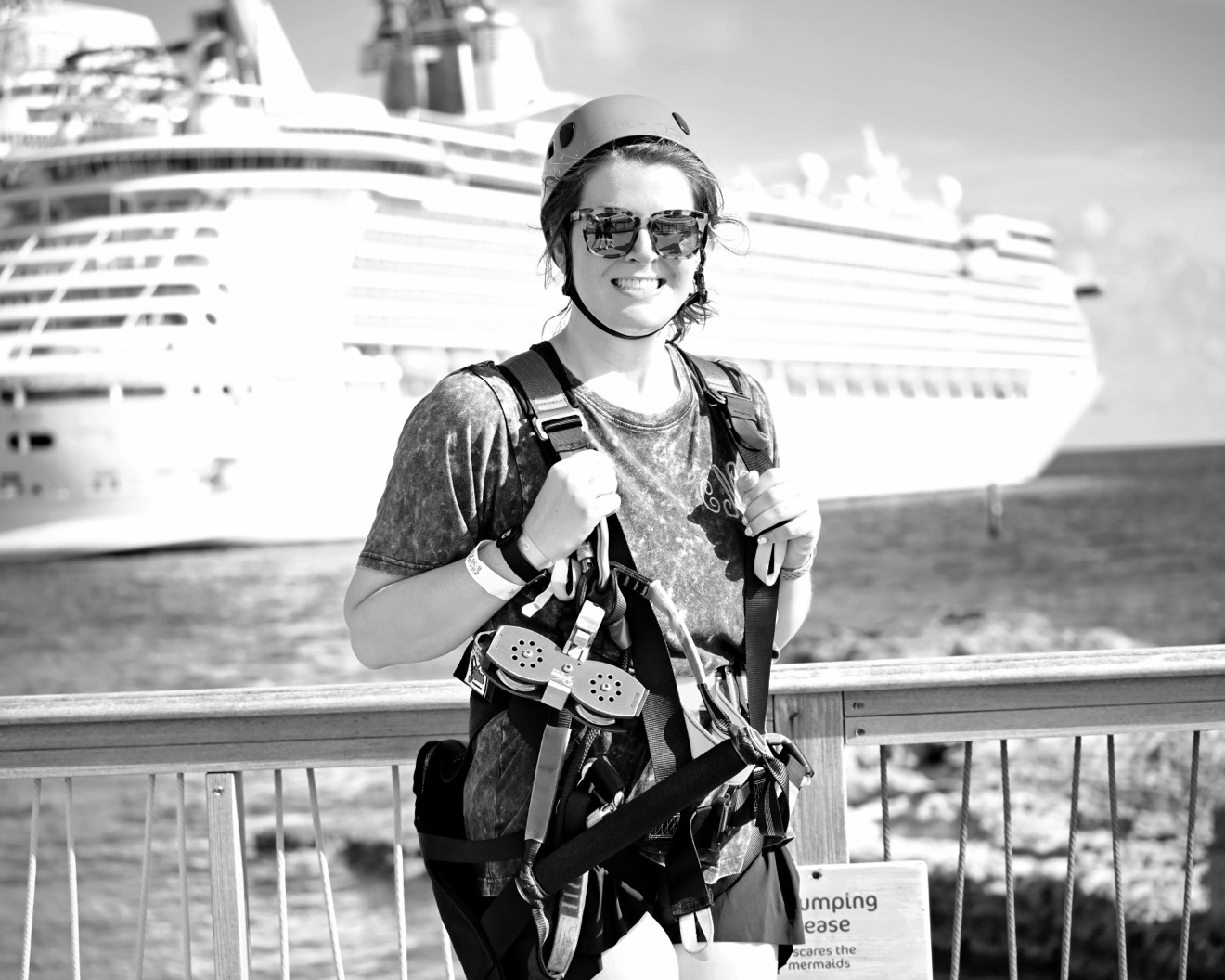 Isaiah’s partner in zip-line gear with a cruise ship behind her